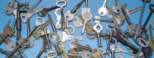 A collection of various keys spread out on a blue background.