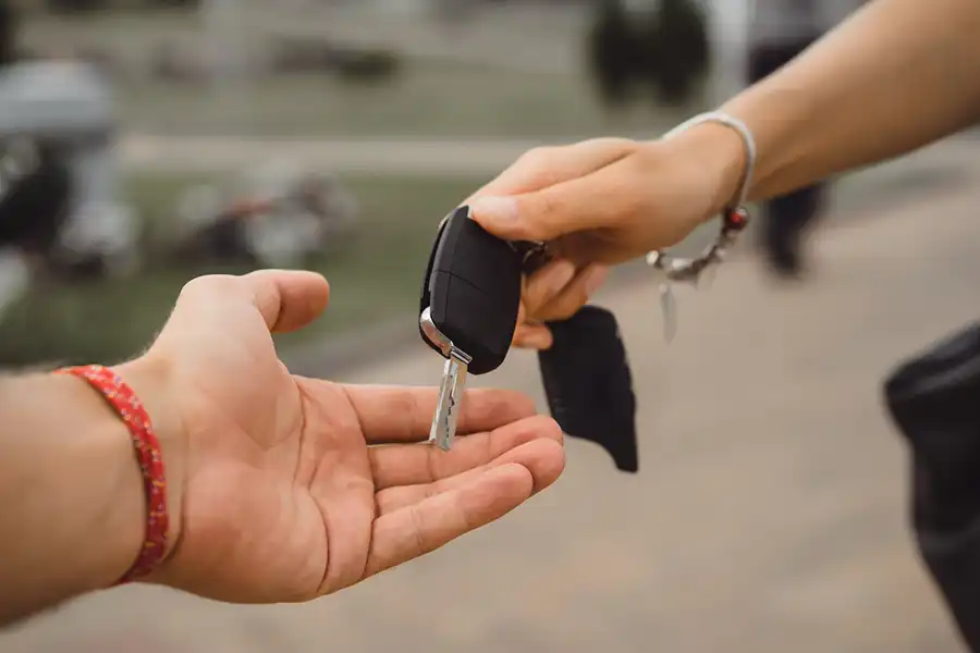 Handing over car keys.