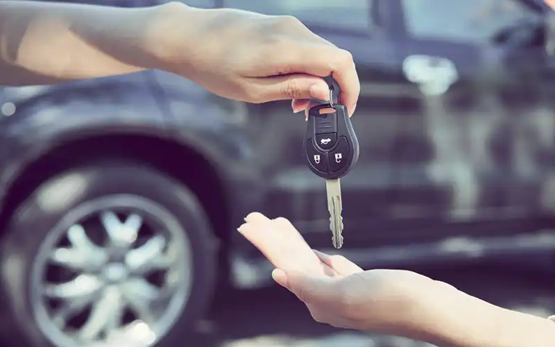 Handing over car keys.